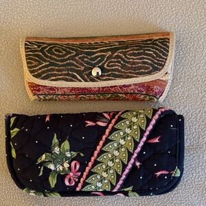 Two eyeglass cases.  One is Vera Bradley. The other is unknown